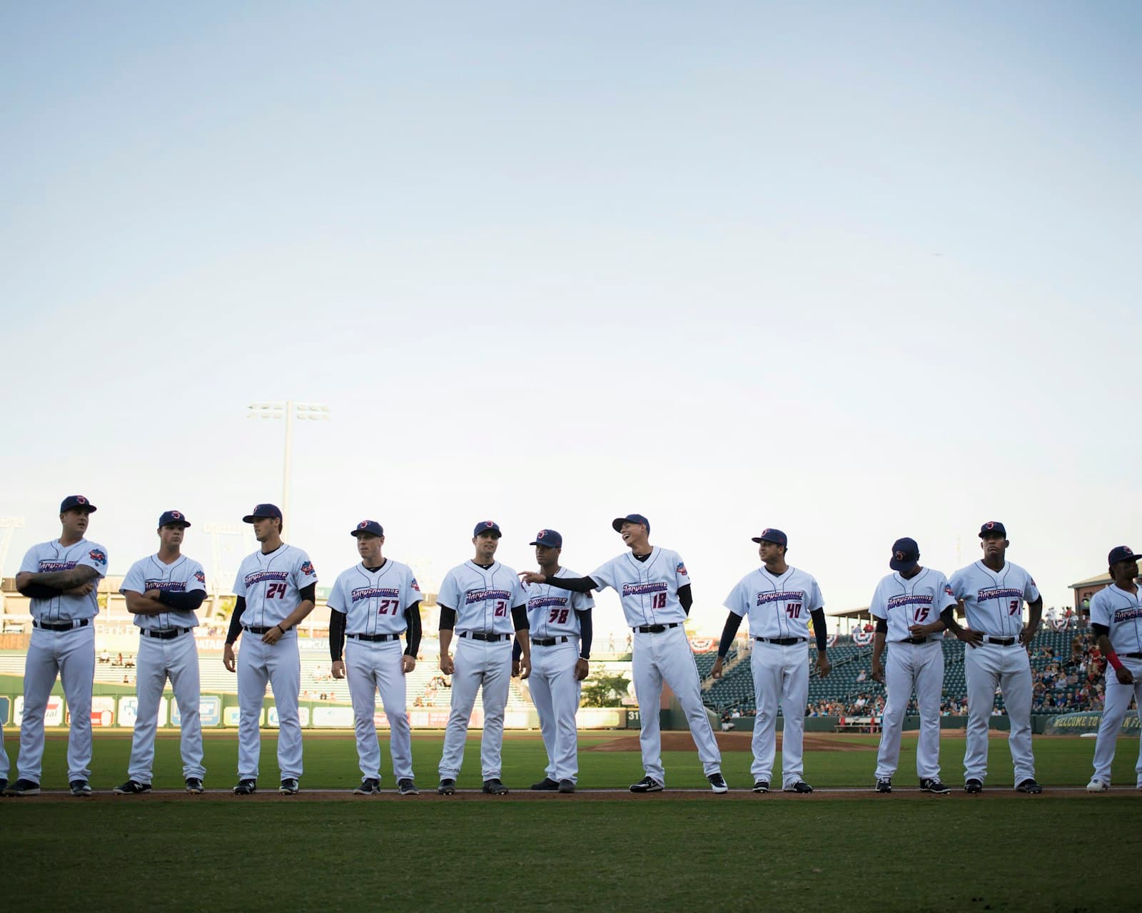 A baseball team lined up along the foul line before a game